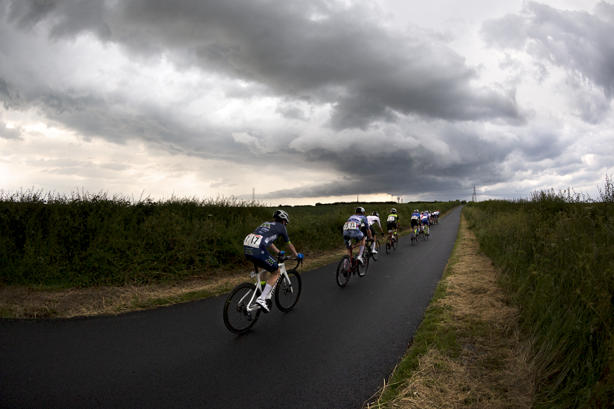 British National Road Championships 2023 - Men’s Road Race - The last riders pass by near Brotton under stormy skies