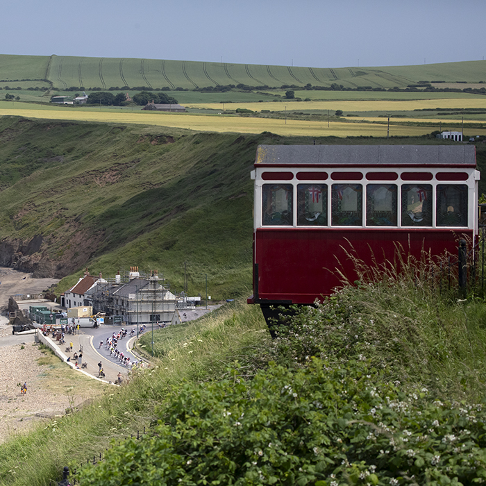 British National Road Championships 2023 - Men’s Road Race - The race on the sea front from a distance with the funicular railway in the foreground