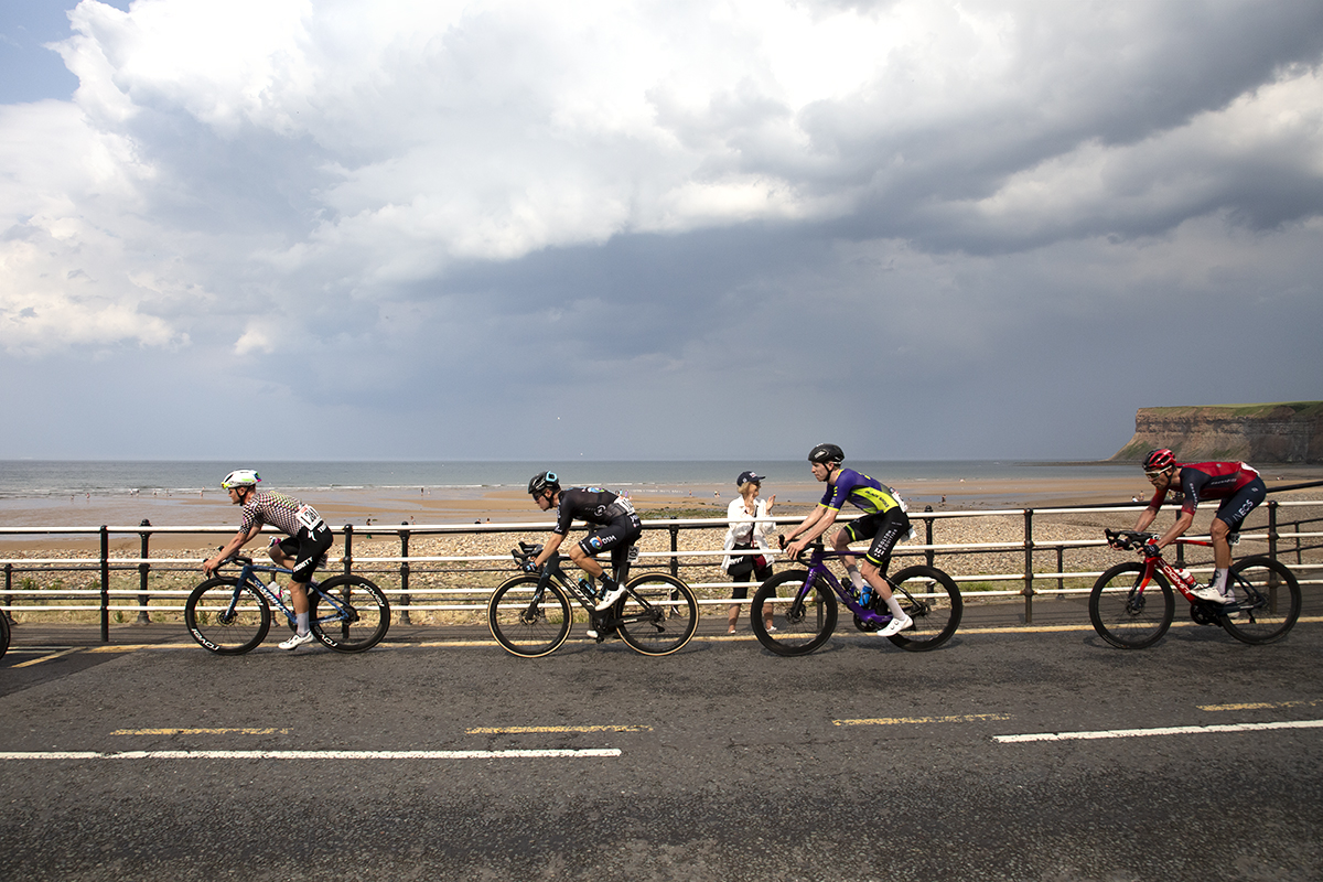 British National Road Championships 2023 - Men’s Road Race - Riders race down the seafront cheered on by a female fan