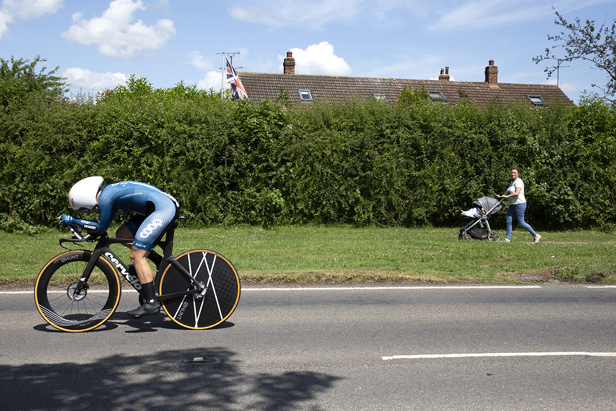 British National Road Championships 2023 - Women’s Time Trial - Jessica Roberts of Team Coop-Hitec Products passes a women pushing a pram during the competition