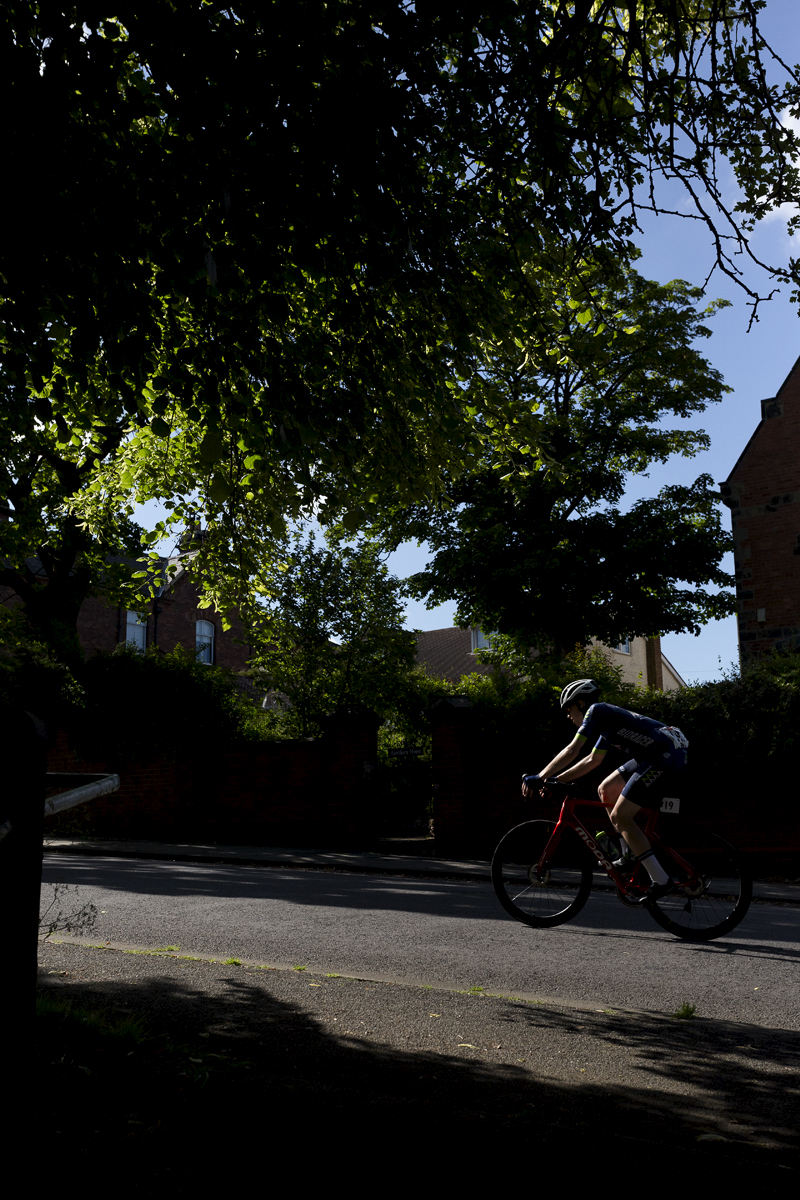 British National Road Championships 2024 - Men’s Road Race -David Hird races through the shadows cast by the trees at the side of the road