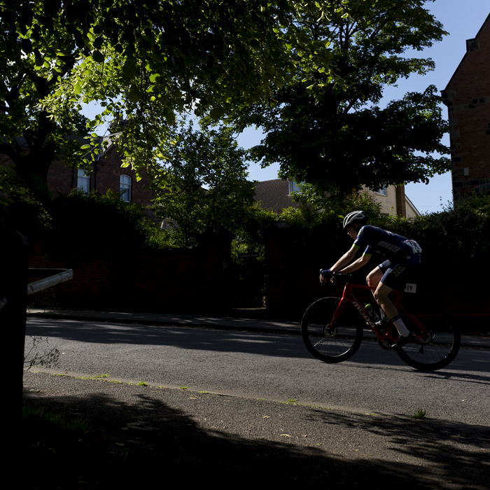 British National Road Championships 2024 - Men’s Road Race -David Hird races through the shadows cast by the trees at the side of the road