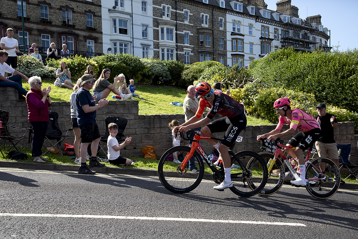 British National Road Championships 2024 - Men’s Road Race - Josh Tarling looks behind him to see Owain Doull following closely as they pass by crowds on the climb in Saltburn