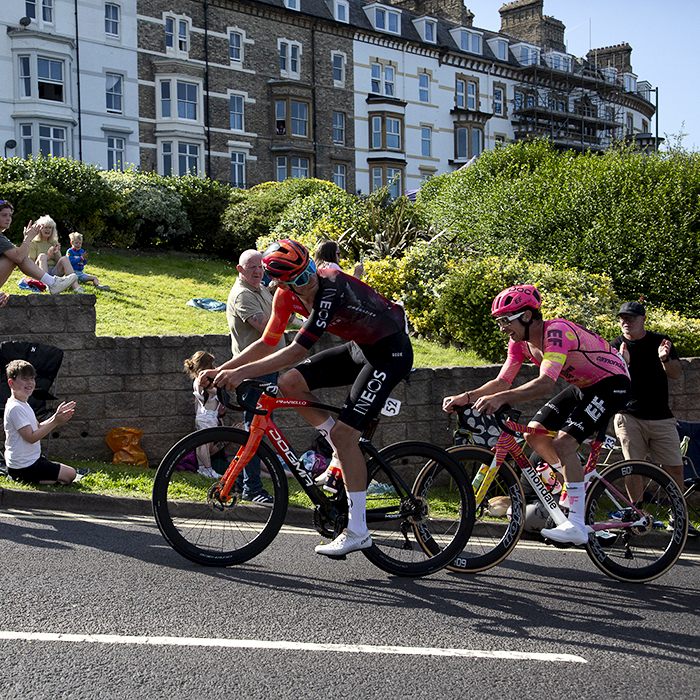 British National Road Championships 2024 - Men’s Road Race - Josh Tarling looks behind him to see Owain Doull following closely as they pass by crowds on the climb in Saltburn