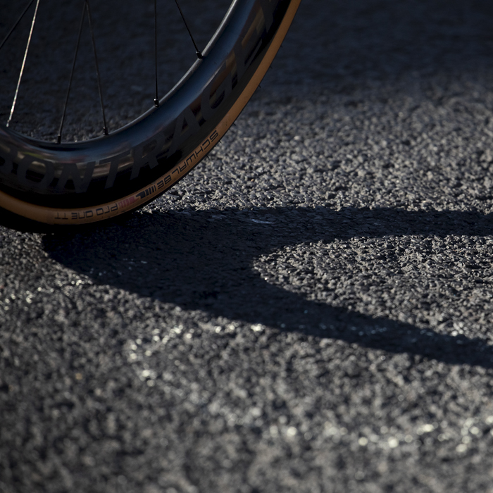 British National Road Championships 2024 - Men’s Road Race - Schwalbe Pro One TT - A bike wheel casts a shadow on the road