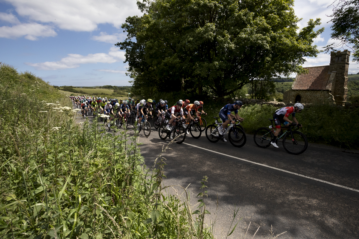 British National Road Championships 2024 - Men’s Road Race - The peloton passes by a small church in Upleatham