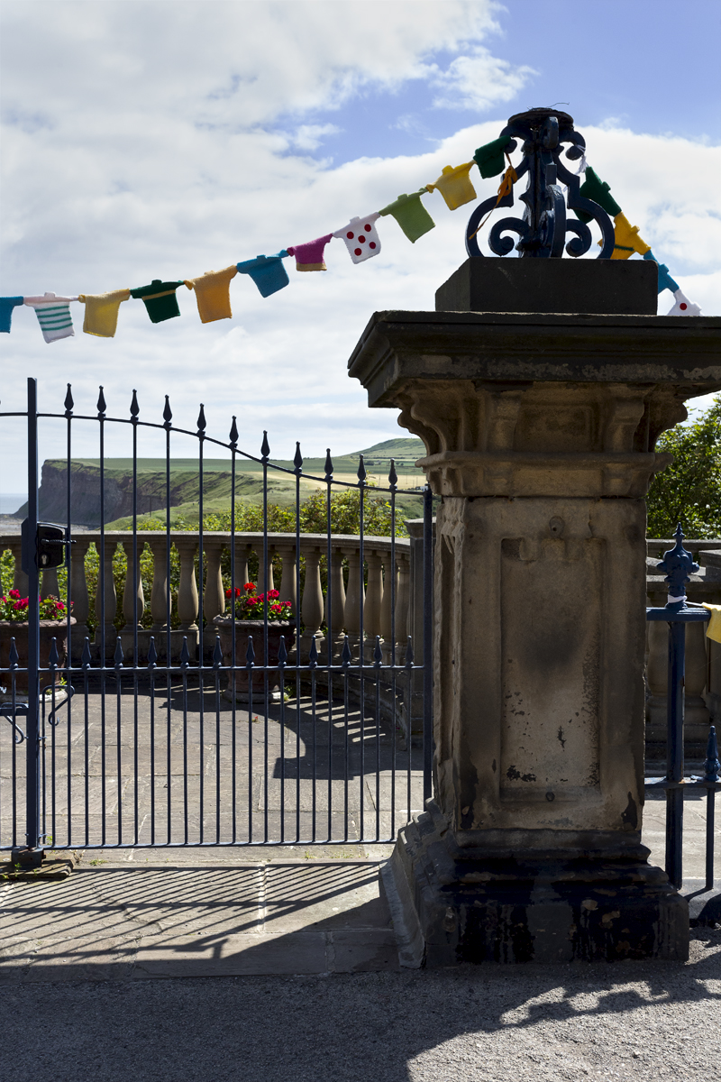 British National Road Championships 2024 - Women’s Road Race - Cliffs are framed by an ornate gate with knitted cycling jersey bunting hanging from it