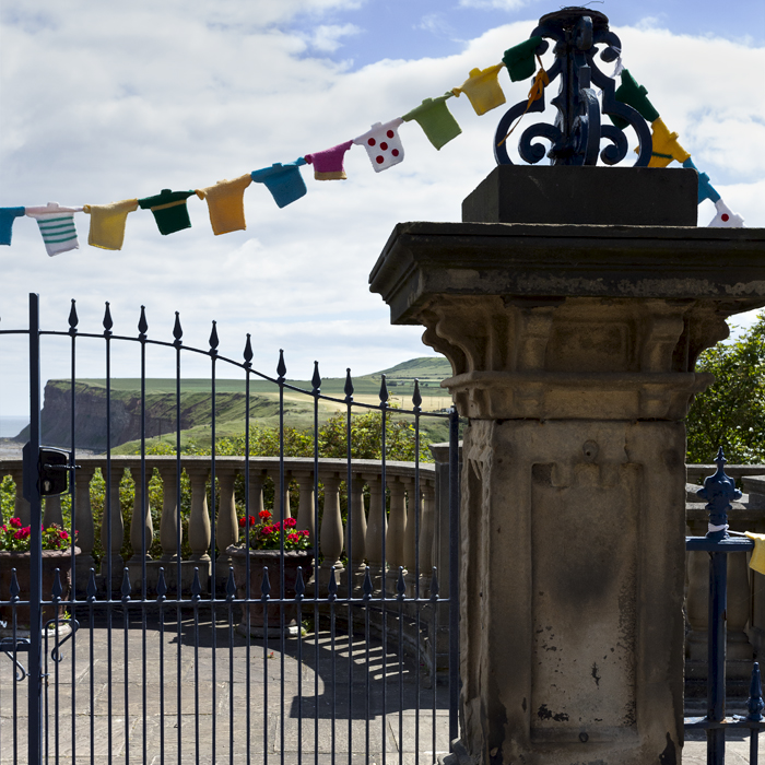 British National Road Championships 2024 - Women’s Road Race - Cliffs are framed by an ornate gate with knitted cycling jersey bunting hanging from it