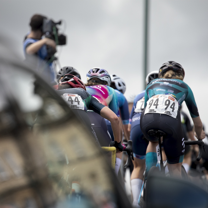 British National Road Championships 2024 - Women’s Road Race - Henrietta Colborne of Roompods from behind as she climbs the hill at Saltburn with a team car in the foreground