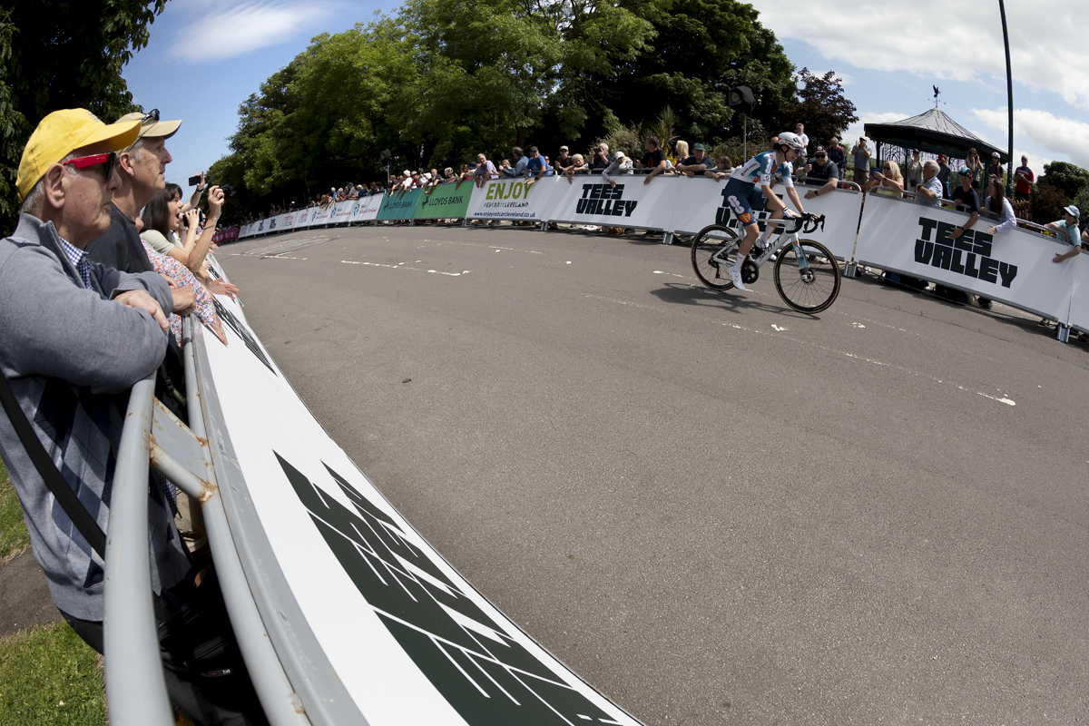 British National Road Championships 2024 - Women’s Road Race - Pfeiffer Georgi solos past the advertising hoardings as fans watch on as she rides to victory