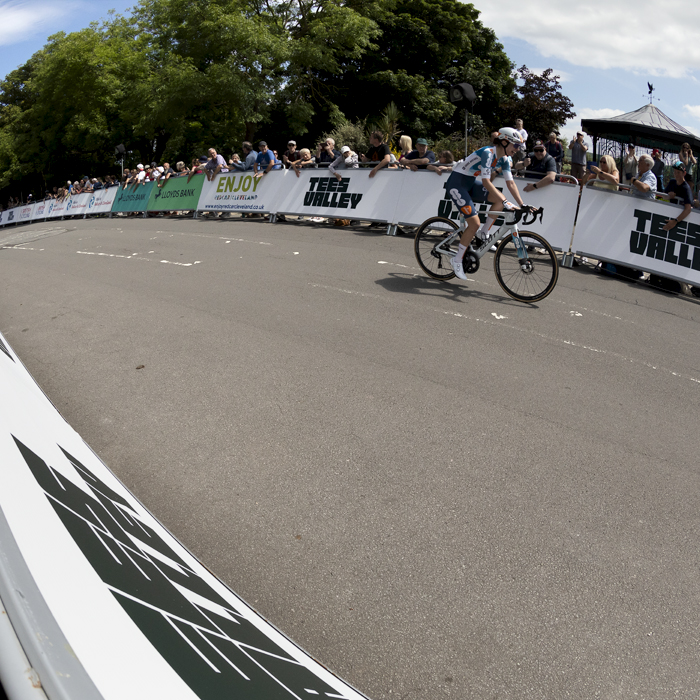 British National Road Championships 2024 - Women’s Road Race - Pfeiffer Georgi solos past the advertising hoardings as fans watch on as she rides to victory