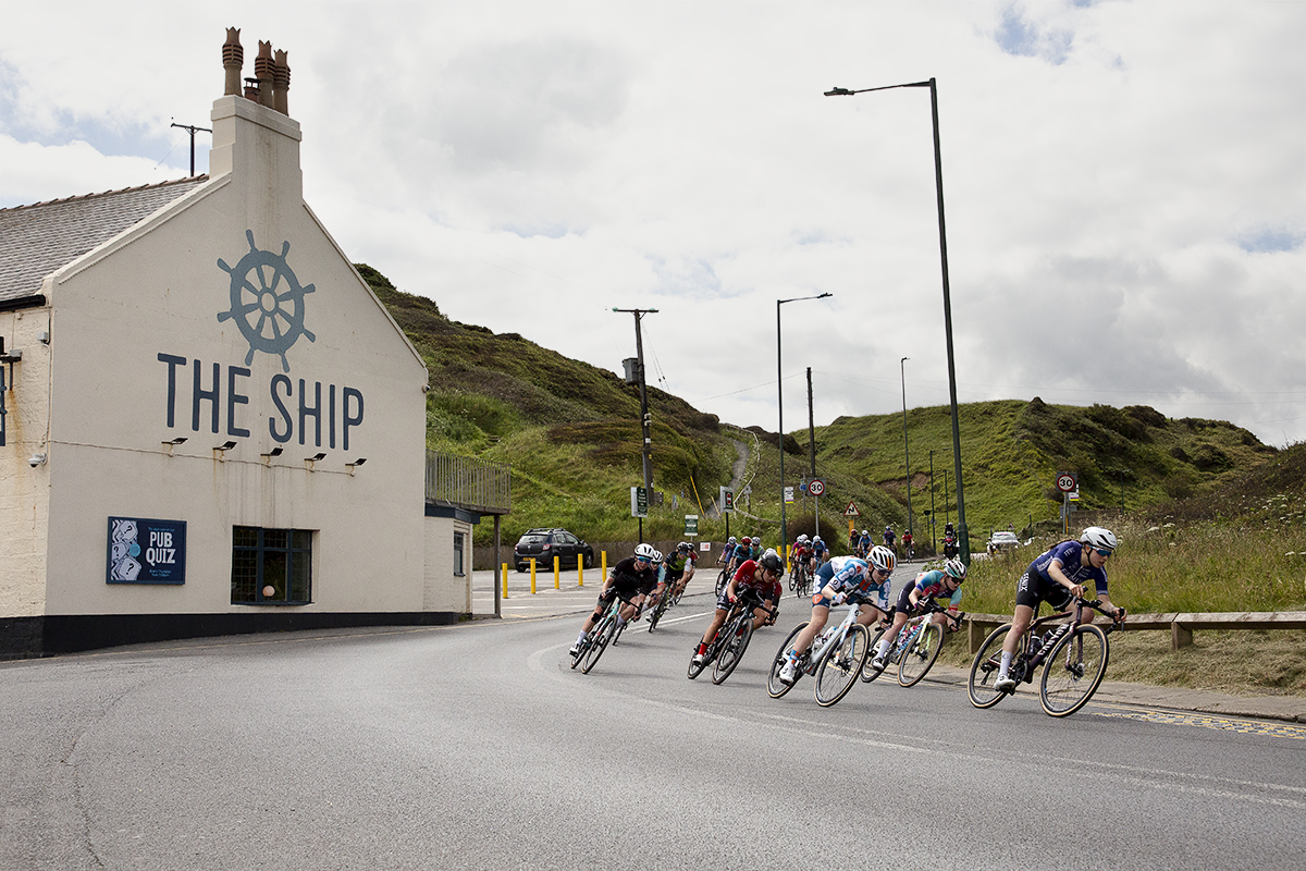 British National Road Championships 2024 - Women’s Road Race - The peloton descend onto the sea front passing by The Ship Inn