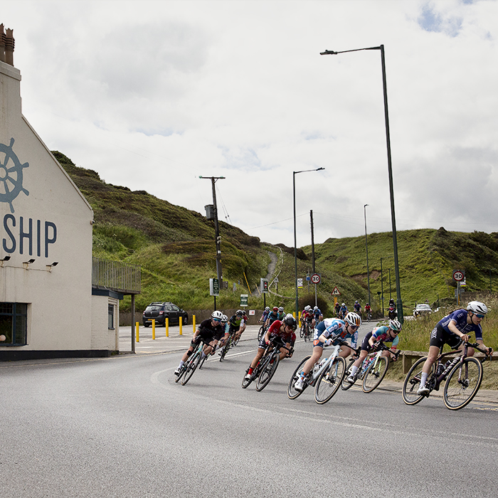 British National Road Championships 2024 - Women’s Road Race - The peloton descend onto the sea front passing by The Ship Inn