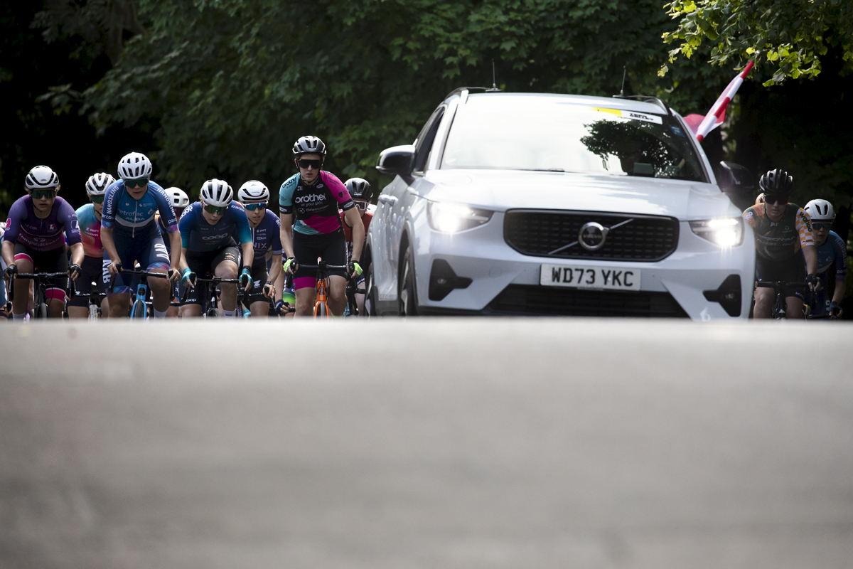 British National Road Championships 2024 - Women’s Road Race - The peloton crests a rise at the start of the race with the race car leading them out