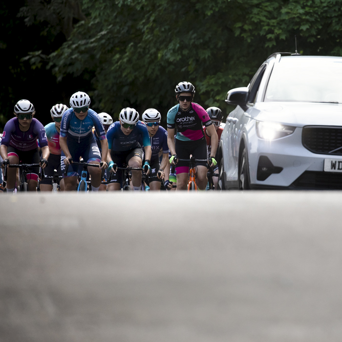 British National Road Championships 2024 - Women’s Road Race - The peloton crests a rise at the start of the race with the race car leading them out