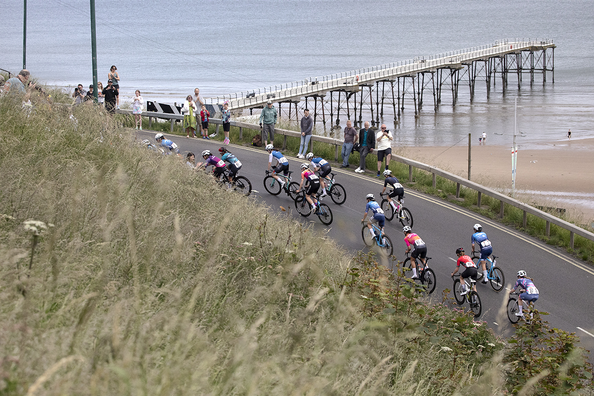 British National Road Championships 2024 - Women’s Road Race - Riders climbs the hill at Saltburn with the pier and beach in the background