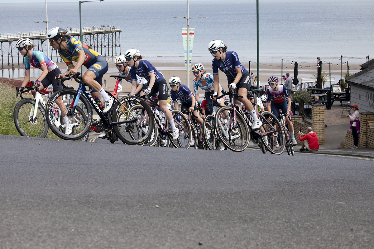 British National Road Championships 2024 - Women’s Road Race - Lizzie Deignan leads a group of riders up the climb at Saltburn with the pier and beach in the background