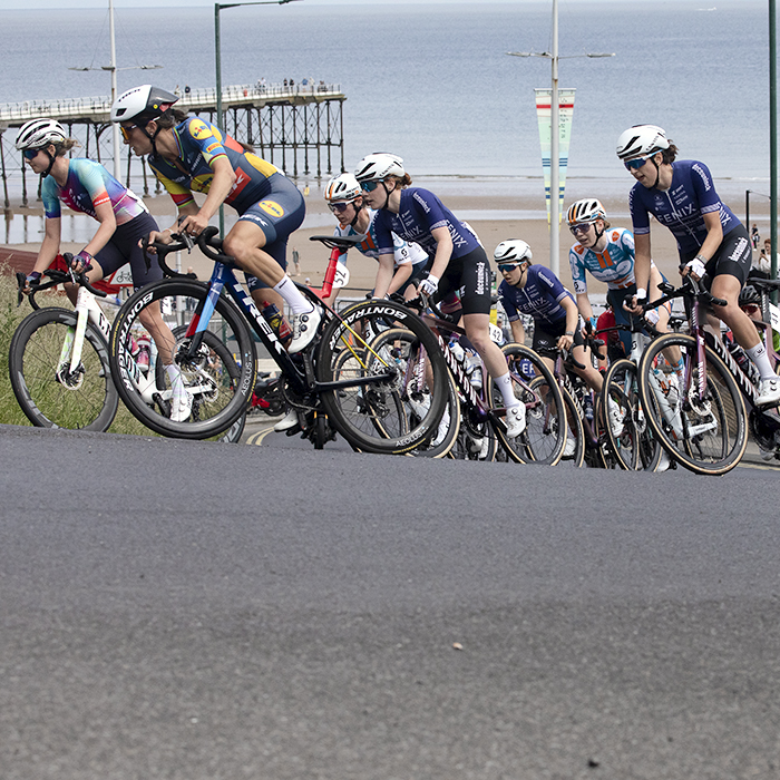 British National Road Championships 2024 - Women’s Road Race - Lizzie Deignan leads a group of riders up the climb at Saltburn with the pier and beach in the background