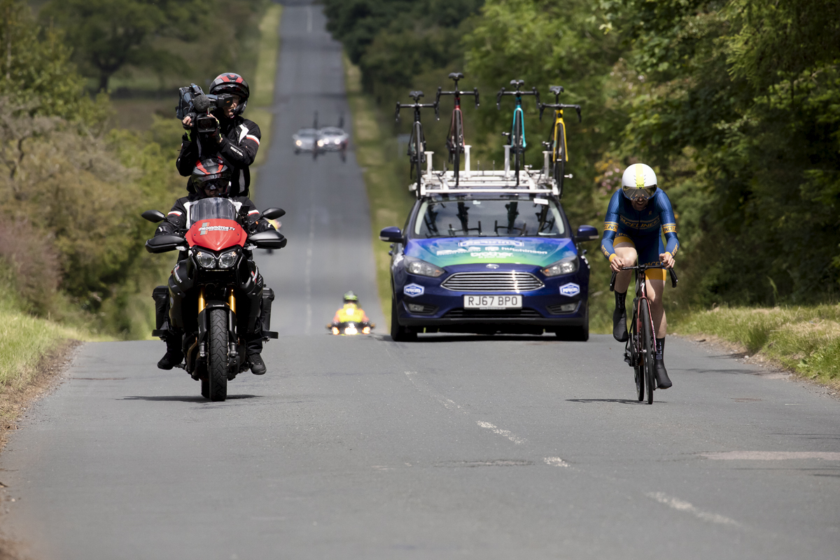 British National Road Championships 2024 -  Men’s Time Trial - Paul Burton is followed by his team car and the video Moto