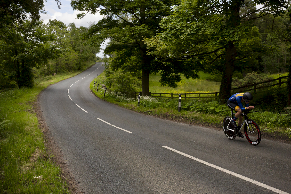 British National Road Championships 2024 - Men’s U23 Time Trial - Harry Codd rides down a road lined by mature trees