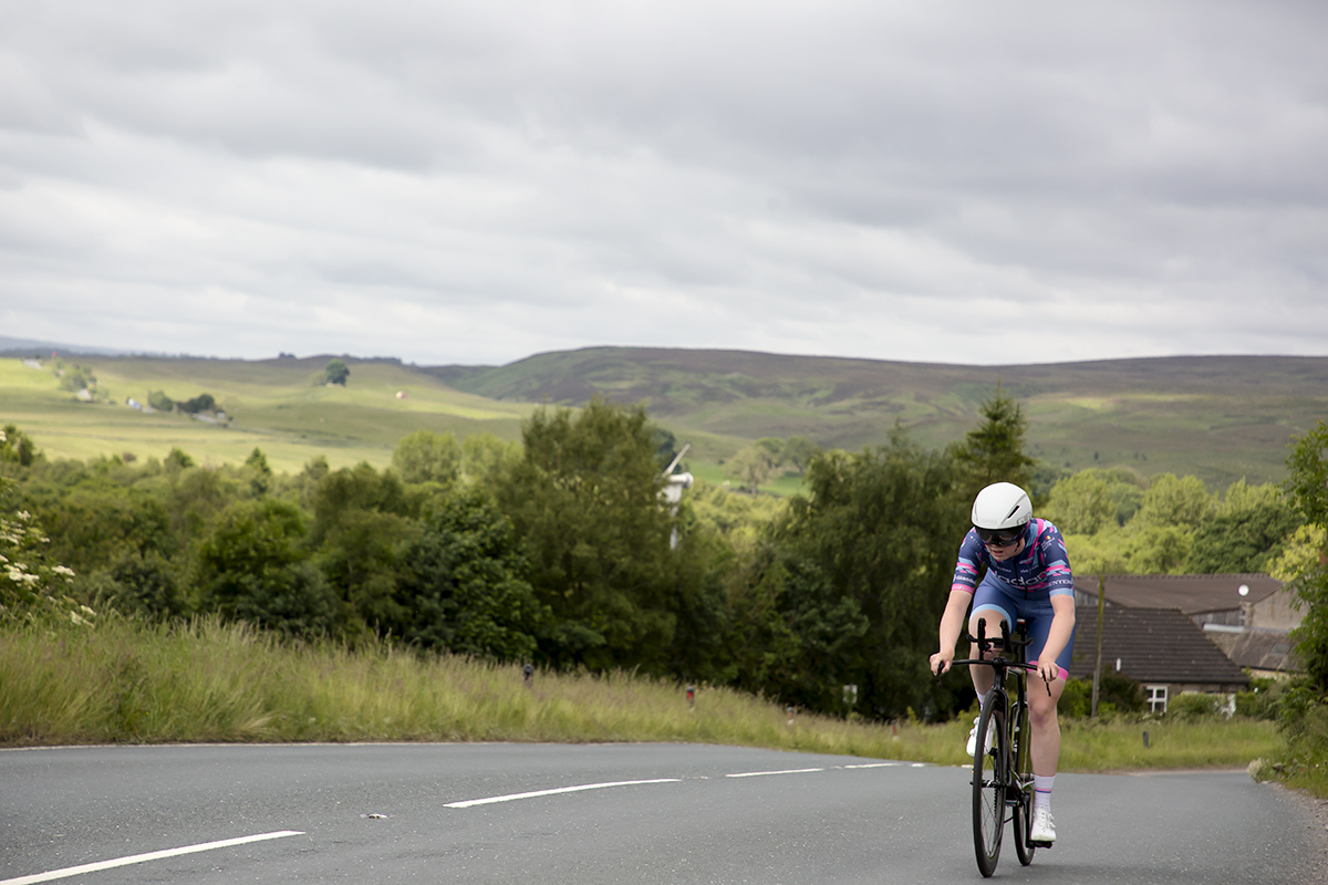 British National Road Championships 2024 - Women’s U23 Time Trial - Isabella Johnson tackles one of the hills on the course with the Yorkshire Dales behind her