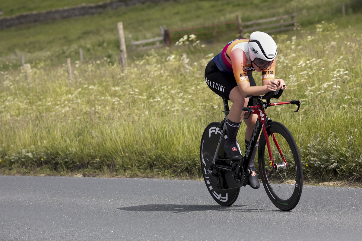 British National Road Championships 2024 - Women’s U23 Time Trial - Matilda McKibben in an aero tuck with verges in flower to her side