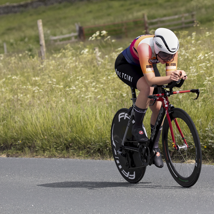 British National Road Championships 2024 - Women’s U23 Time Trial - Matilda McKibben in an aero tuck with verges in flower to her side