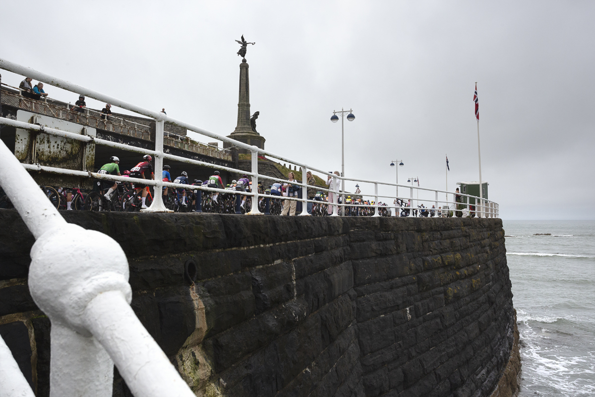 British National Road Championships 2025 - Road Race - Men - Aberystwyth - the race rolls out past an obelisk with a statue on the top