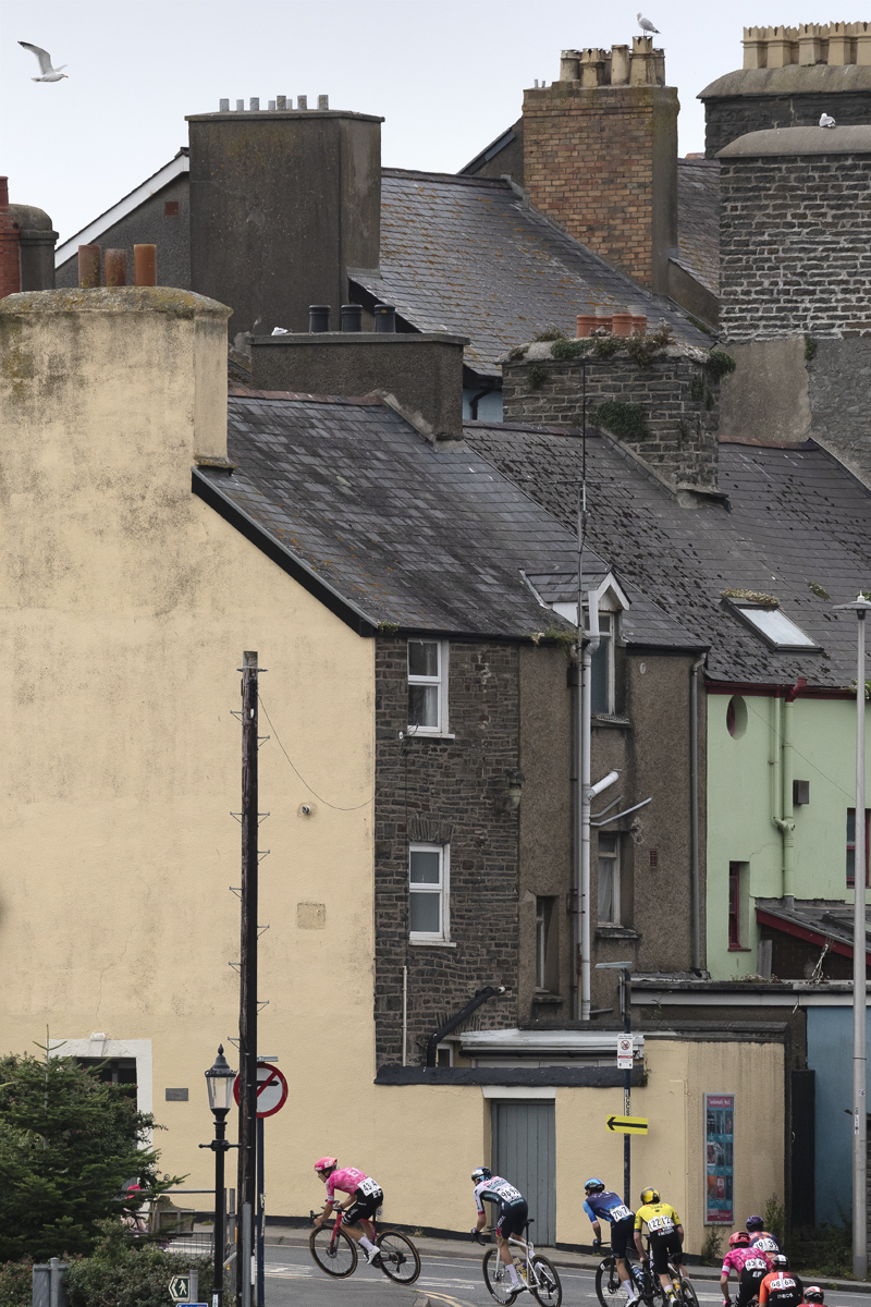 British National Road Championships 2025 - Road Race - Men - riders race past a row of terraced houses in Aberystwyth