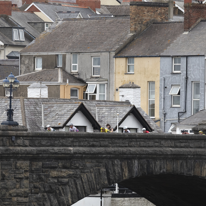 British National Road Championships 2025 - Road Race - Men - riders on the bridge in Aberystwyth with terraced housing in the background