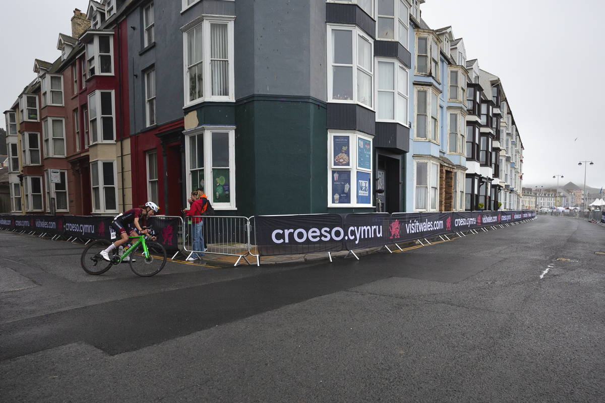 British National Road Championships 2025 - Road Race - Women - Anna Boniface rounds the corner past traditional seaside properties