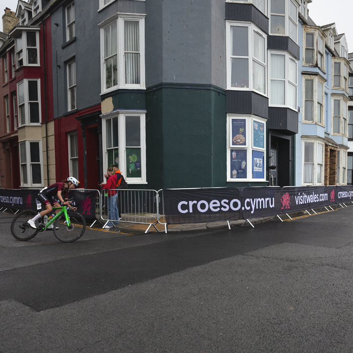 British National Road Championships 2025 - Road Race - Women - Anna Boniface rounds the corner past traditional seaside properties