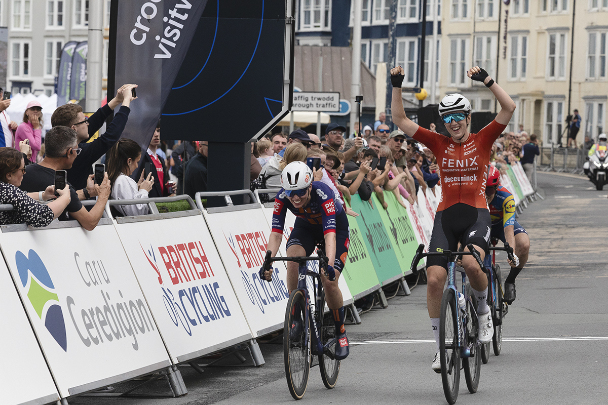 British National Road Championships 2025 - Road Race - Women - Millie Couzens of TeamFenix-Deceuninck raises her hands above her head as she takes the win narrowly beating Pfeiffer Georgi in a sprint