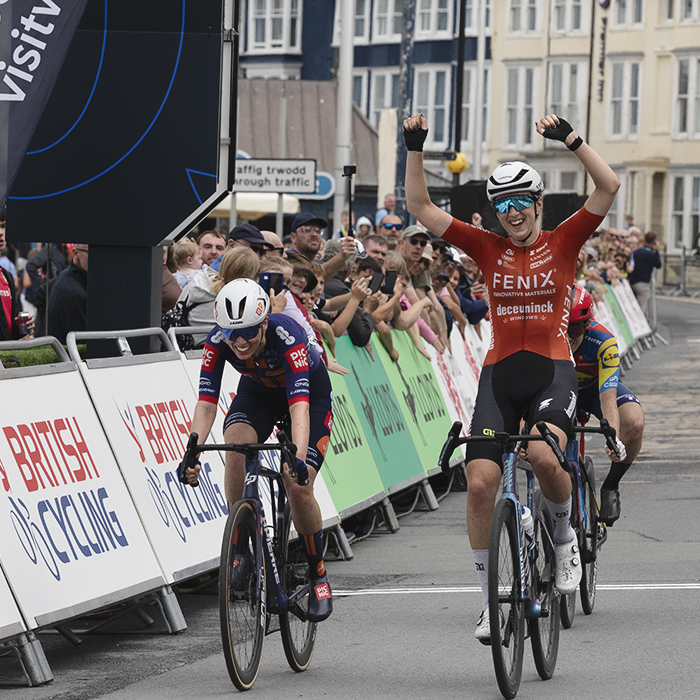 British National Road Championships 2025 - Road Race - Women - Millie Couzens of TeamFenix-Deceuninck raises her hands above her head as she takes the win narrowly beating Pfeiffer Georgi in a sprint