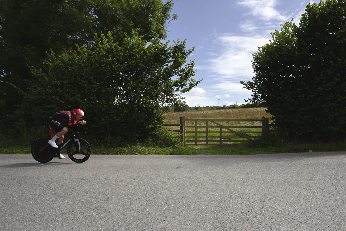 British National Road Championships 2025 - Time Trial - Elite Men - Connor Swift of Ineos Grenadiers races past a wooden five bar gate