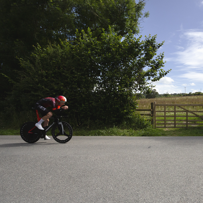 British National Road Championships 2025 - Time Trial - Elite Men - Connor Swift of Ineos Grenadiers races past a wooden five bar gate