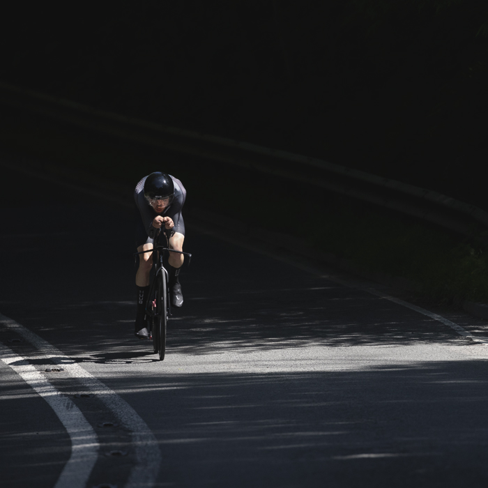 British National Road Championships 2025 - Time Trial - Elite Men - Toby Tanfield of Leadout Performance rides through the mottled light on the road