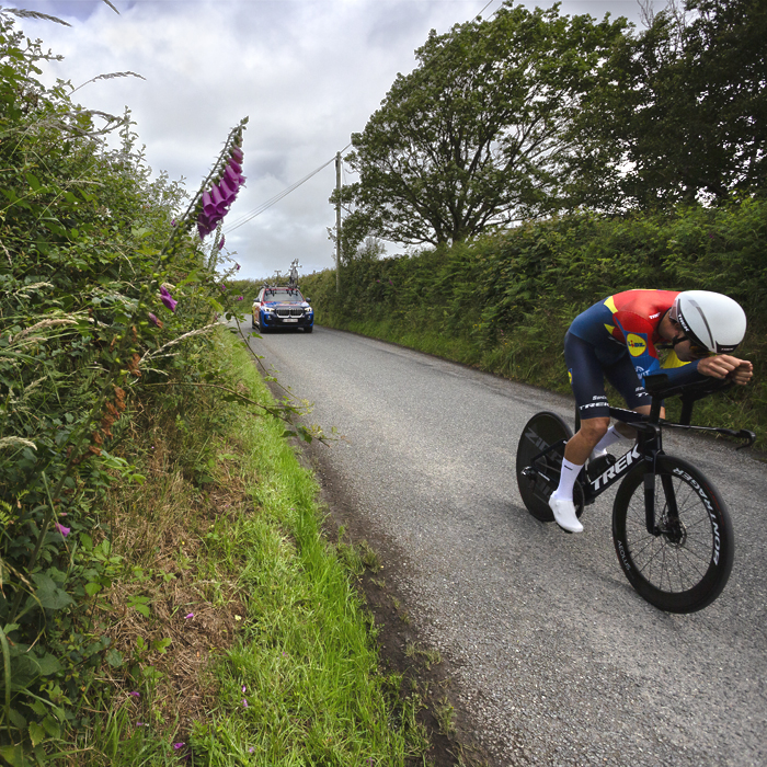 British National Road Championships 2025 - Time Trial - U23 Men - Seb Grindley of Lidl - Trek Future Racing passes foxgloves in the hedgerow
