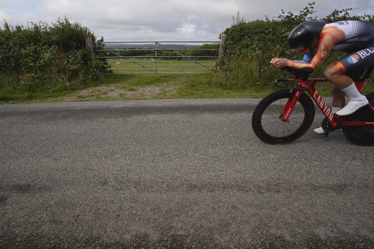 British National Road Championships 2025 - Time Trial - U23 Men - Toby Bush of BCC Race Team passes a field entrance