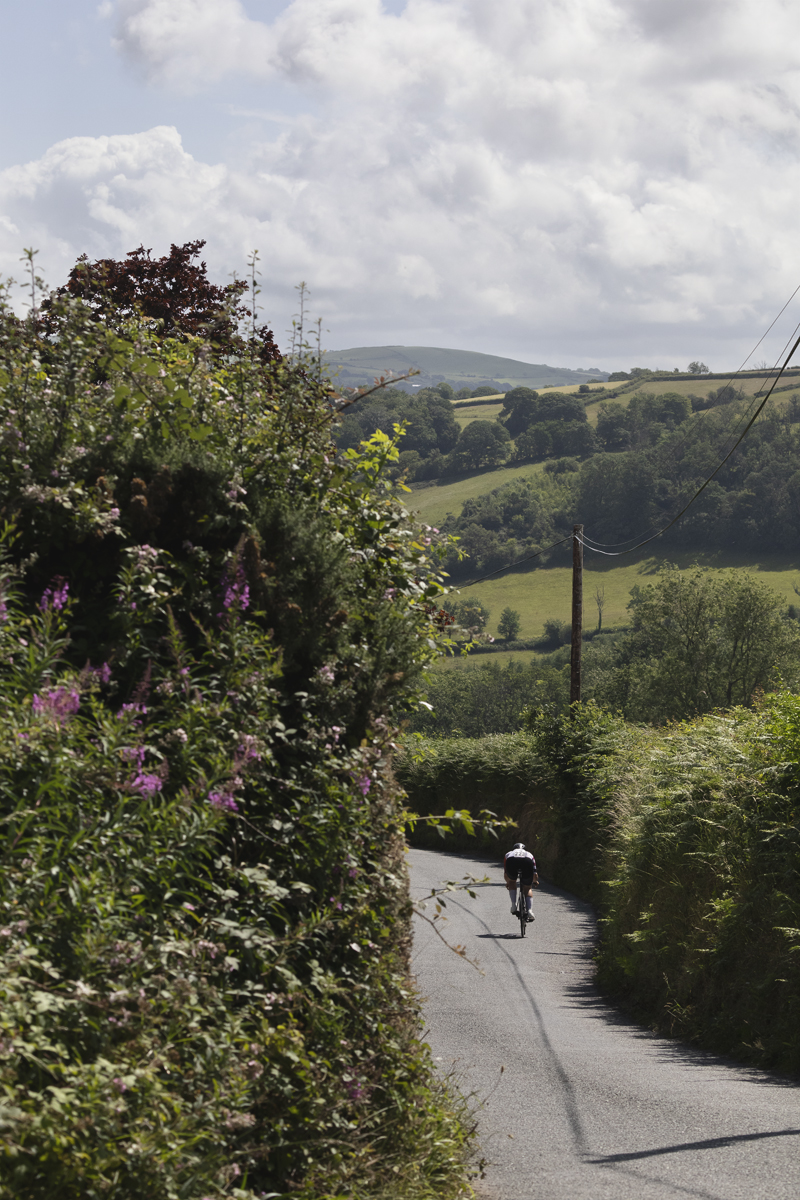British National Road Championships 2025 - Time Trial - Elite Women - Charlotte Hodgkins-Byrne passes through the rolling hills of the countryside outside Aberaeron
