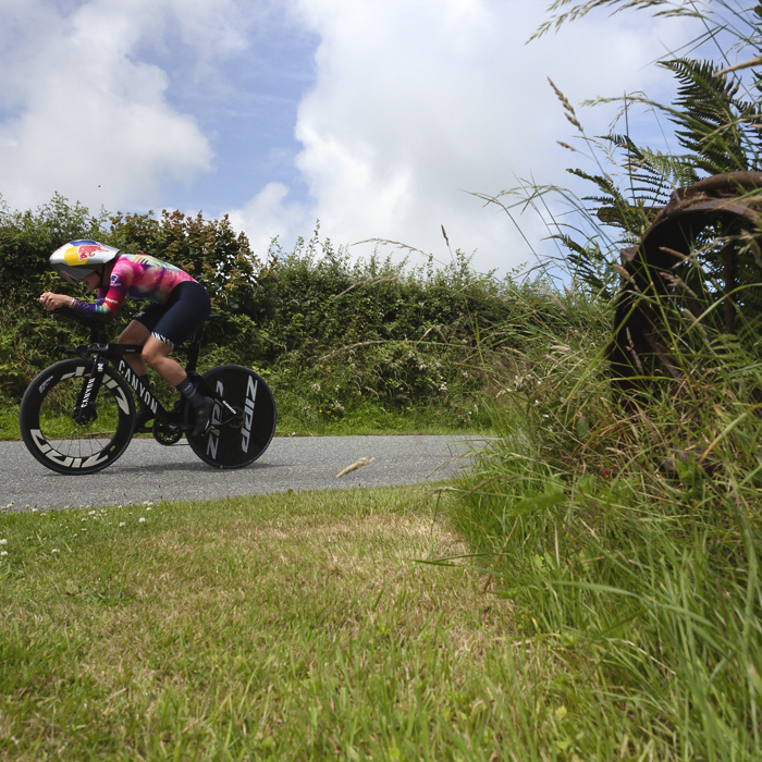 British National Road Championships 2025 - Time Trial - Elite Women - Zoe Bäckstedt passes a gate end with the remnants of old farm machinery