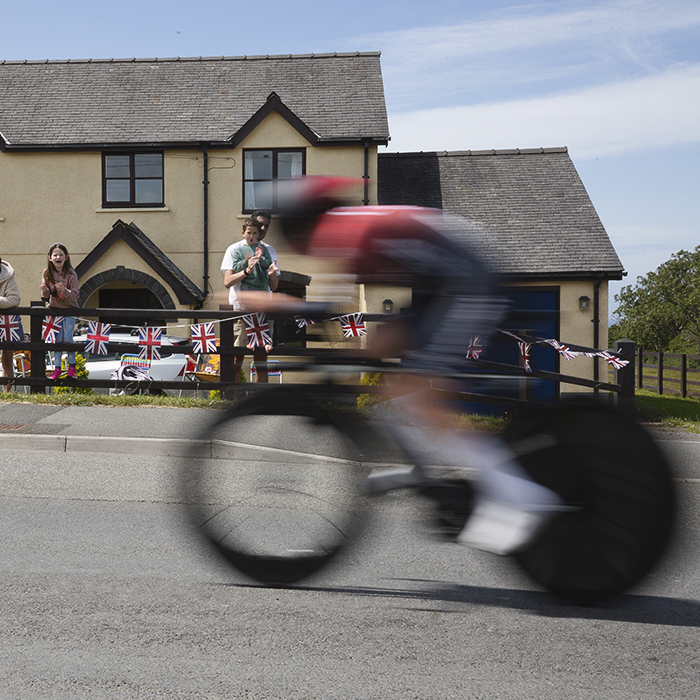 British National Road Championships 2025 - Time Trial - U23 Women - a family cheers on one of the competitors from their garden