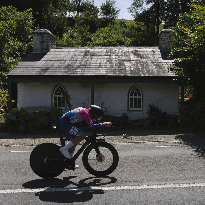 British National Road Championships 2025 - Time Trial - U23 Women - Mari Porton of Handsling Alba Development Road Team passes a small white cottage with arched windows
