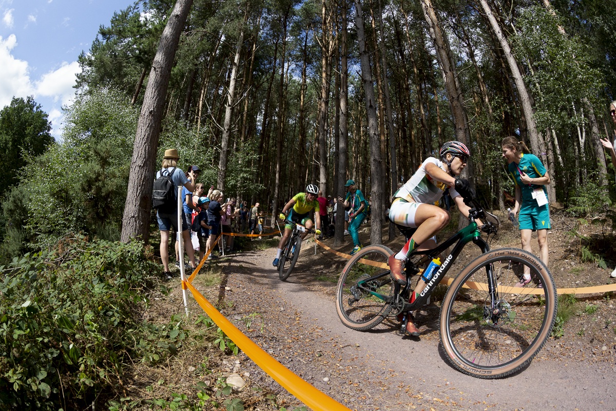 Birmingham 2022 - XXII Commonwealth Games - Mountain Bike - Women - Candice Lill of  South Africa races past stewards in their uniforms