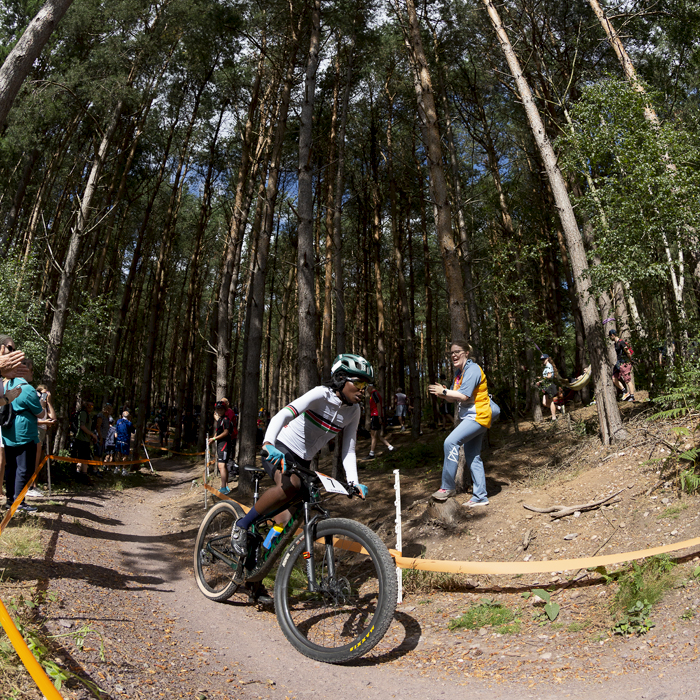 Birmingham 2022 - XXII Commonwealth Games - Mountain Bike - Women - Nancy Akinyi Debe of Kenya races into a sunlit glade