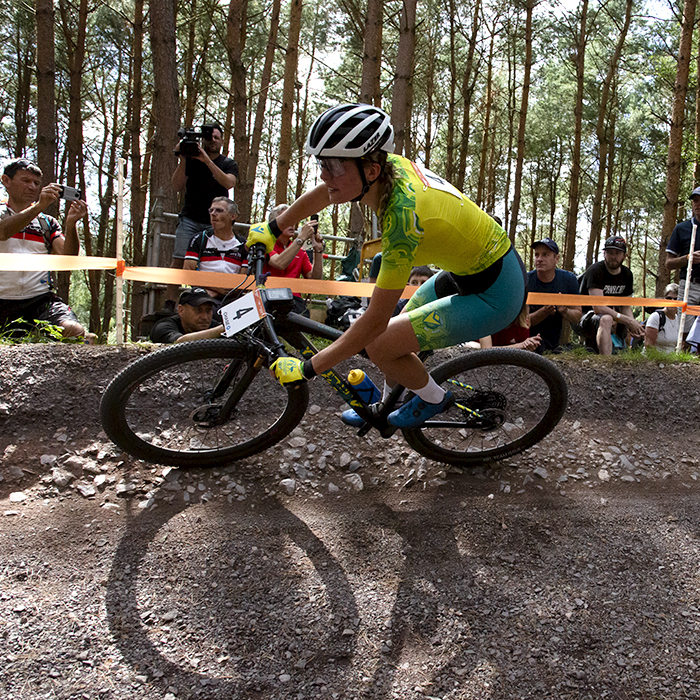 Birmingham 2022 - XXII Commonwealth Games - Mountain Bike - Women - The shadow of Zoe Cuthbert’s bike is visible as the Australian races through the forest