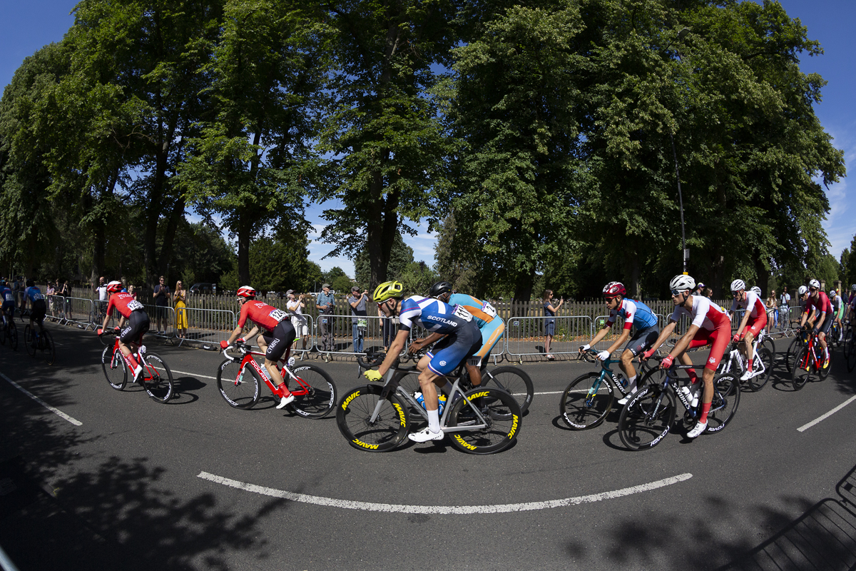 Birmingham 2022 - XXII Commonwealth Games - Men’s Road Race - Charlie Aldridge of Scotland races in front of a park