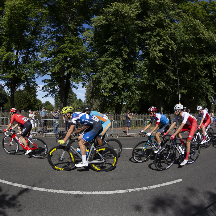 Birmingham 2022 - XXII Commonwealth Games - Men’s Road Race - Charlie Aldridge of Scotland races in front of a park