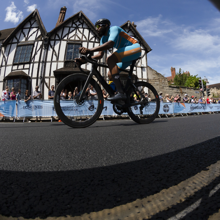 Birmingham 2022 - XXII Commonwealth Games - Men’s Road Race - Hasani Hennis of Anguilla races past a Tudor building