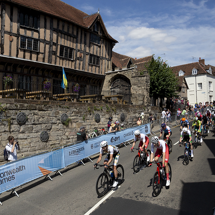 Birmingham 2022 - XXII Commonwealth Games - Men’s Road Race - Riders pass the Tudor building of Lord Lycester Hospital